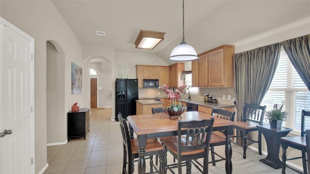 11017 Casitas Dr, Austin, TX 78717 - dining room with arched walkways, light tile patterned floors, plenty of natural light, and vaulted ceiling