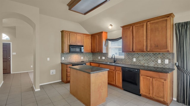 11017 Casitas Dr, Austin, TX 78717 - kitchen featuring vaulted ceiling, dark countertops, black appliances, light tile patterned floors, and a kitchen island