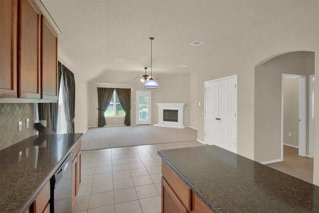 11017 Casitas Dr, Austin, TX 78717 - kitchen featuring arched walkways, a glass covered fireplace, light tile patterned flooring, dishwashing machine, and a ceiling fan