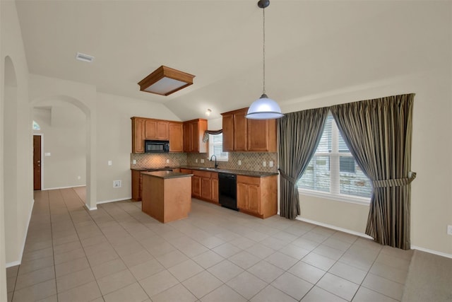 11017 Casitas Dr, Austin, TX 78717 - kitchen with arched walkways, lofted ceiling, healthy amount of natural light, decorative backsplash, and a kitchen island