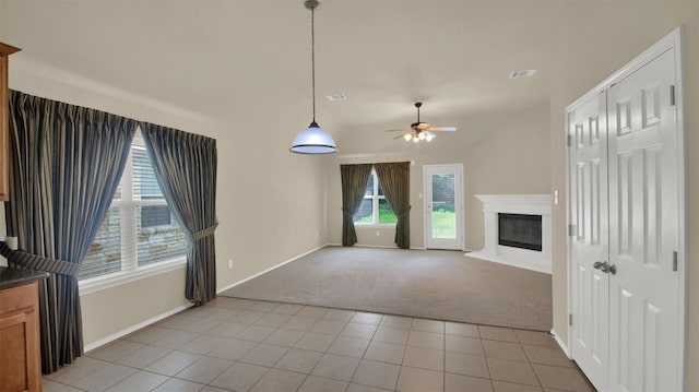 11017 Casitas Dr, Austin, TX 78717 - unfurnished living room featuring light colored carpet, a ceiling fan, light tile patterned floors, and a glass covered fireplace