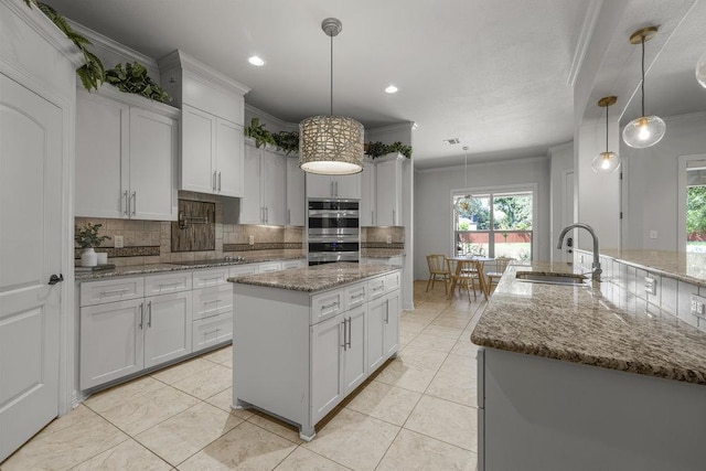 100 Eagle Landing Dr, Belton, TX 76513 - kitchen with a center island, backsplash, crown molding, plenty of natural light, and stainless steel double oven