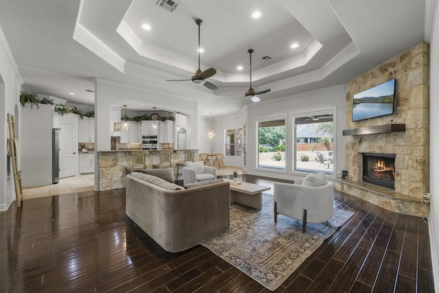100 Eagle Landing Dr, Belton, TX 76513 - living room with a tray ceiling, ornamental molding, ceiling fan, a fireplace, and wood finished floors