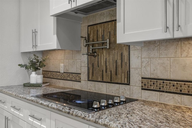 100 Eagle Landing Dr, Belton, TX 76513 - kitchen featuring backsplash, white cabinetry, black electric stovetop, and light stone counters