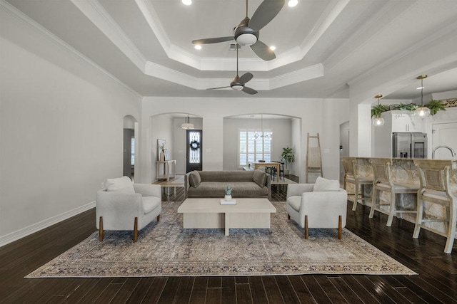 100 Eagle Landing Dr, Belton, TX 76513 - living room featuring arched walkways, a tray ceiling, ceiling fan, dark wood-style floors, and crown molding