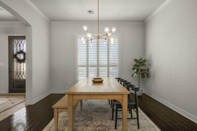 100 Eagle Landing Dr, Belton, TX 76513 - dining room featuring arched walkways, wood finished floors, healthy amount of natural light, a chandelier, and crown molding