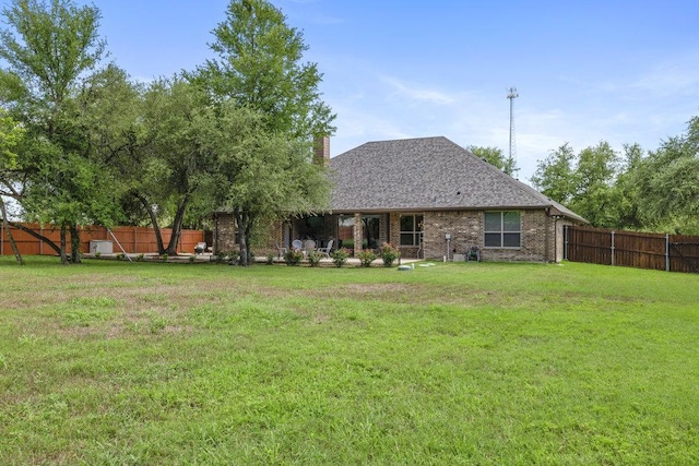 100 Eagle Landing Dr, Belton, TX 76513 - back of property featuring a fenced backyard, brick siding, a chimney, and a shingled roof