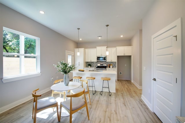 6111 Carnation Ter Unit 1, Austin, TX 78741 - dining space featuring light wood-style floors and recessed lighting