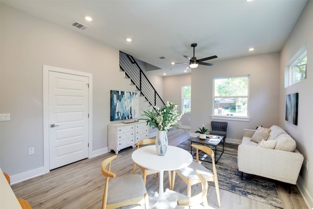 6111 Carnation Ter Unit 1, Austin, TX 78741 - living area with ceiling fan, light wood finished floors, healthy amount of natural light, stairs, and recessed lighting