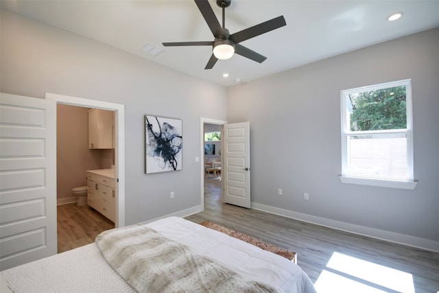 6111 Carnation Ter Unit 1, Austin, TX 78741 - bedroom with light wood-type flooring, recessed lighting, ensuite bath, and ceiling fan