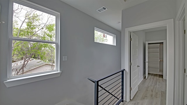 6111 Carnation Ter Unit 1, Austin, TX 78741 - hallway with an upstairs landing and light wood-style floors
