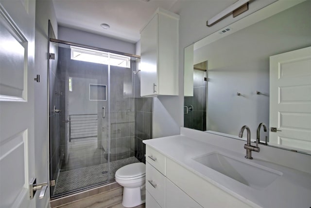 6111 Carnation Ter Unit 1, Austin, TX 78741 - bathroom featuring vanity, a stall shower, and wood finished floors