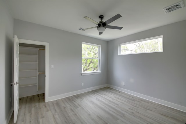 6111 Carnation Ter Unit 1, Austin, TX 78741 - unfurnished bedroom featuring wood finished floors, a spacious closet, and a ceiling fan