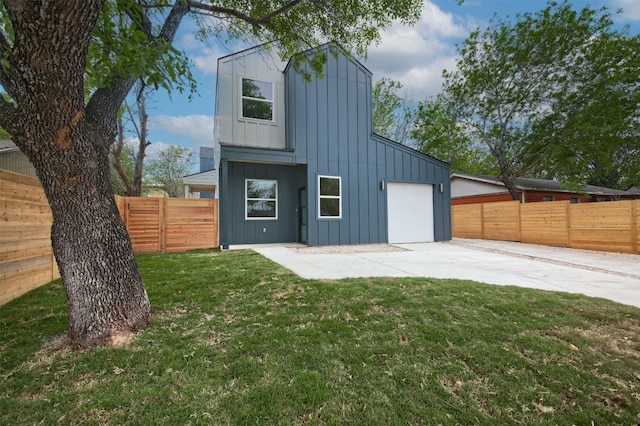 6111 Carnation Ter Unit 1, Austin, TX 78741 - back of house with board and batten siding, a garage, concrete driveway, and a fenced backyard