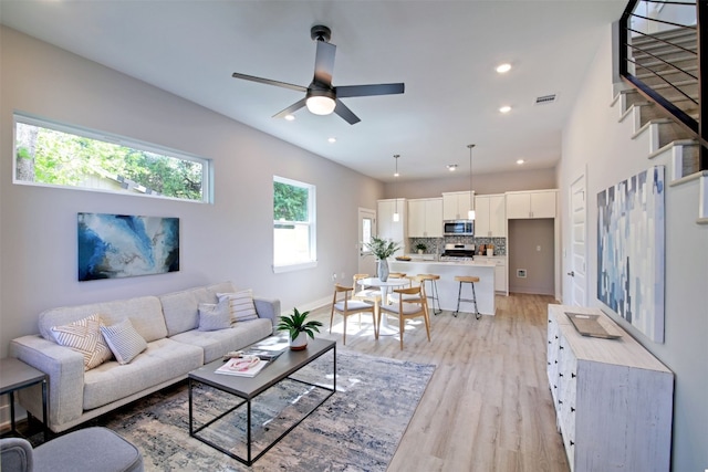 6111 Carnation Ter Unit 1, Austin, TX 78741 - living area with light wood-style flooring, a ceiling fan, recessed lighting, and stairway