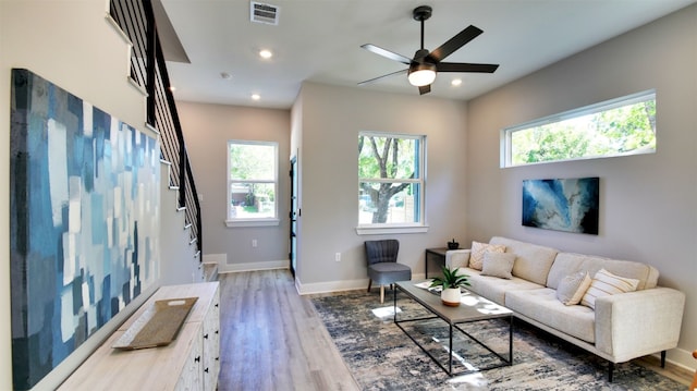 6111 Carnation Ter Unit 1, Austin, TX 78741 - living area featuring light wood-style floors, recessed lighting, a ceiling fan, and stairway