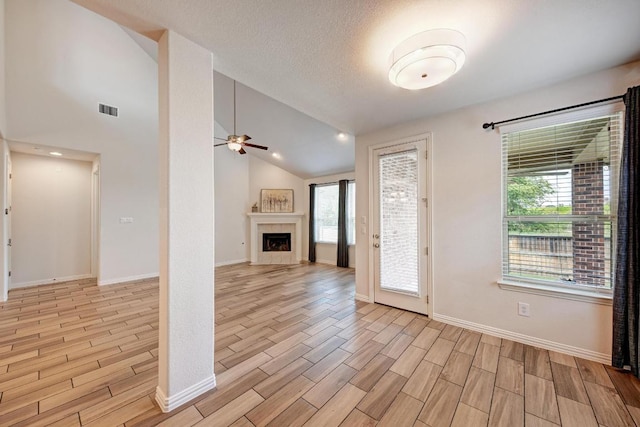 2953 Diego Dr, Round Rock, TX 78665 - foyer with ceiling fan, light wood-style flooring, a tile fireplace, and lofted ceiling