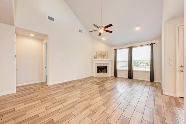 2953 Diego Dr, Round Rock, TX 78665 - unfurnished living room featuring ceiling fan, high vaulted ceiling, a tile fireplace, light wood-style floors, and recessed lighting