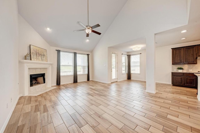 2953 Diego Dr, Round Rock, TX 78665 - unfurnished living room featuring a ceiling fan, a fireplace, high vaulted ceiling, recessed lighting, and light wood-type flooring
