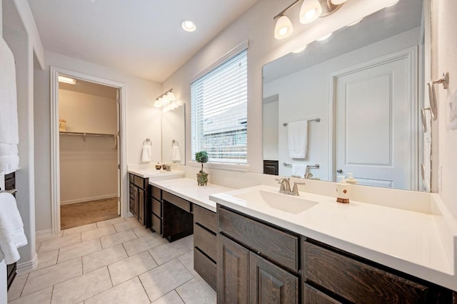 2953 Diego Dr, Round Rock, TX 78665 - full bathroom with double vanity, a walk in closet, plenty of natural light, and tile patterned floors
