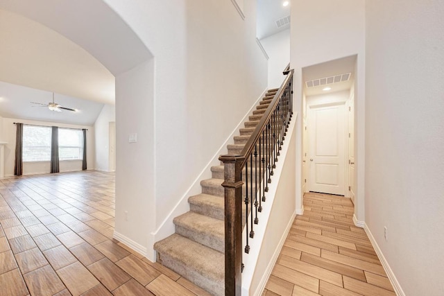 2953 Diego Dr, Round Rock, TX 78665 - stairs featuring wood finish floors, arched walkways, ceiling fan, and lofted ceiling