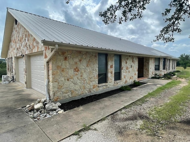 817 Mountain Creek Rd, Marble Falls, TX 78654 - view of side of property with a metal roof and stone siding