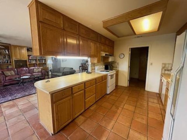 817 Mountain Creek Rd, Marble Falls, TX 78654 - kitchen featuring light countertops, white appliances, open floor plan, brown cabinetry, and decorative backsplash