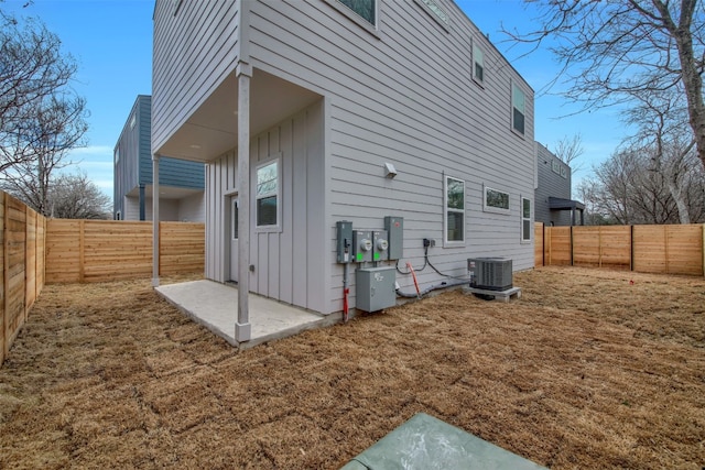 1104 Begonia Ter Unit 2, Austin, TX 78741 - rear view of property with board and batten siding, a patio area, and a fenced backyard