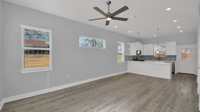 1104 Begonia Ter Unit 2, Austin, TX 78741 - unfurnished living room featuring a ceiling fan, light wood finished floors, and recessed lighting
