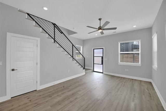 1104 Begonia Ter Unit 2, Austin, TX 78741 - unfurnished living room featuring stairs, plenty of natural light, wood finished floors, and recessed lighting