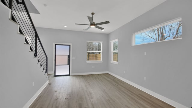 1104 Begonia Ter Unit 2, Austin, TX 78741 - unfurnished living room with wood finished floors, a ceiling fan, recessed lighting, and stairway