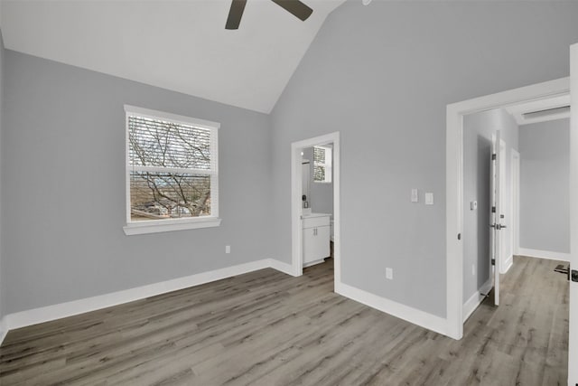 1104 Begonia Ter Unit 2, Austin, TX 78741 - unfurnished bedroom featuring multiple windows, wood finished floors, high vaulted ceiling, and ensuite bath