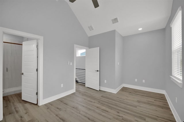 1104 Begonia Ter Unit 2, Austin, TX 78741 - unfurnished bedroom featuring wood finished floors, high vaulted ceiling, and ceiling fan