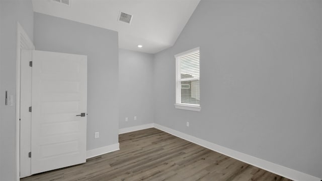 1104 Begonia Ter Unit 2, Austin, TX 78741 - unfurnished bedroom with lofted ceiling, wood finished floors, and recessed lighting