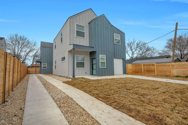 1104 Begonia Ter Unit 2, Austin, TX 78741 - view of front of home featuring board and batten siding, a fenced backyard, driveway, and an attached garage