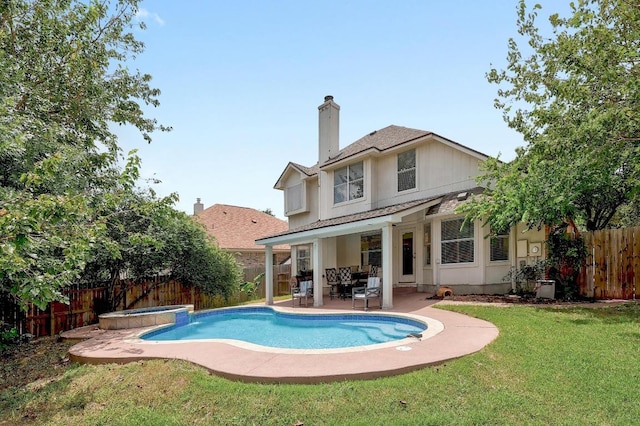15433 Ozone Pl, Austin, TX 78728 - back of house with a fenced backyard, a chimney, a patio area, and a pool with connected hot tub