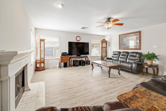 15433 Ozone Pl, Austin, TX 78728 - living area featuring a ceiling fan, healthy amount of natural light, and light wood finished floors