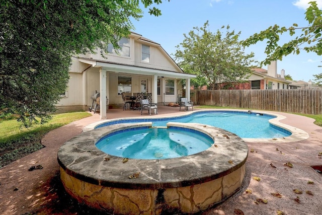 15433 Ozone Pl, Austin, TX 78728 - view of swimming pool featuring a fenced backyard, a patio area, and a pool with connected hot tub
