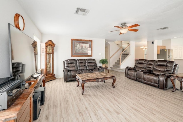 15433 Ozone Pl, Austin, TX 78728 - living room with light wood-type flooring, stairs, ceiling fan, and a chandelier