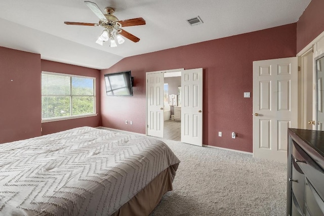 15433 Ozone Pl, Austin, TX 78728 - carpeted bedroom featuring vaulted ceiling, ensuite bath, and a ceiling fan