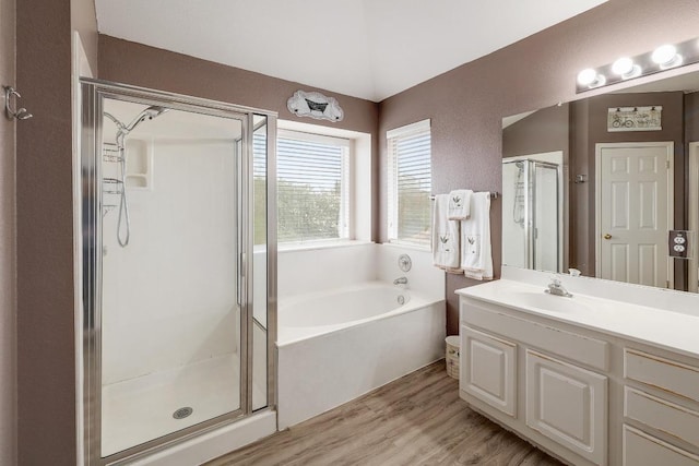 15433 Ozone Pl, Austin, TX 78728 - full bathroom featuring a stall shower, a bath, vanity, and wood finished floors