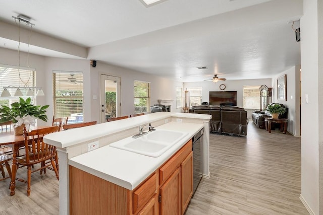 15433 Ozone Pl, Austin, TX 78728 - kitchen with light wood-style flooring, ceiling fan, open floor plan, and light countertops