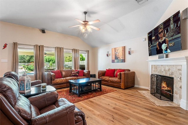 700 Stokesay Castle Path, Pflugerville, TX 78660 - living area with lofted ceiling, wood finished floors, a ceiling fan, plenty of natural light, and a tile fireplace