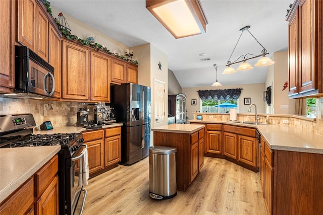 700 Stokesay Castle Path, Pflugerville, TX 78660 - kitchen with appliances with stainless steel finishes, brown cabinetry, light wood-type flooring, decorative backsplash, and vaulted ceiling