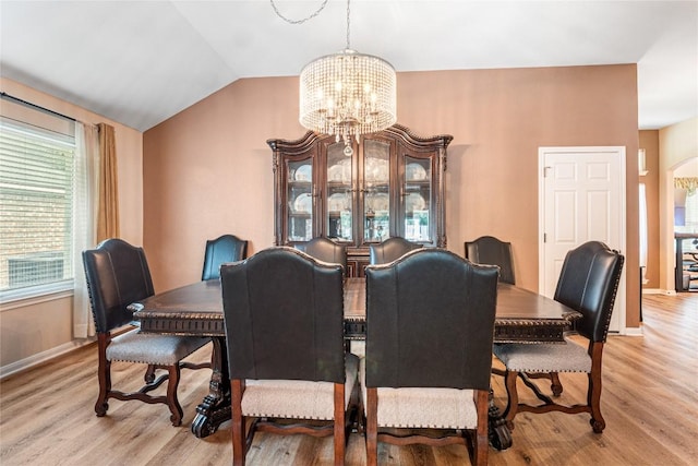 700 Stokesay Castle Path, Pflugerville, TX 78660 - dining space with a chandelier, light wood-style floors, arched walkways, and vaulted ceiling