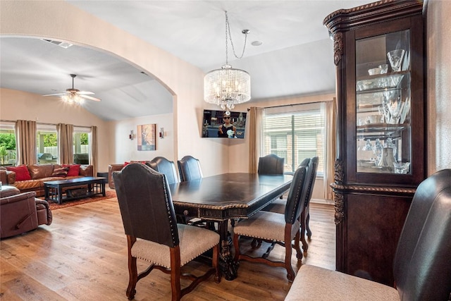 700 Stokesay Castle Path, Pflugerville, TX 78660 - dining space with lofted ceiling, plenty of natural light, arched walkways, light wood finished floors, and a chandelier