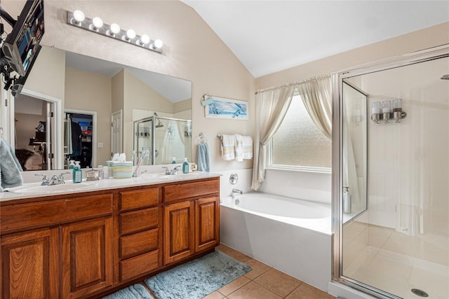 700 Stokesay Castle Path, Pflugerville, TX 78660 - full bathroom with lofted ceiling, a stall shower, a garden tub, tile patterned flooring, and double vanity