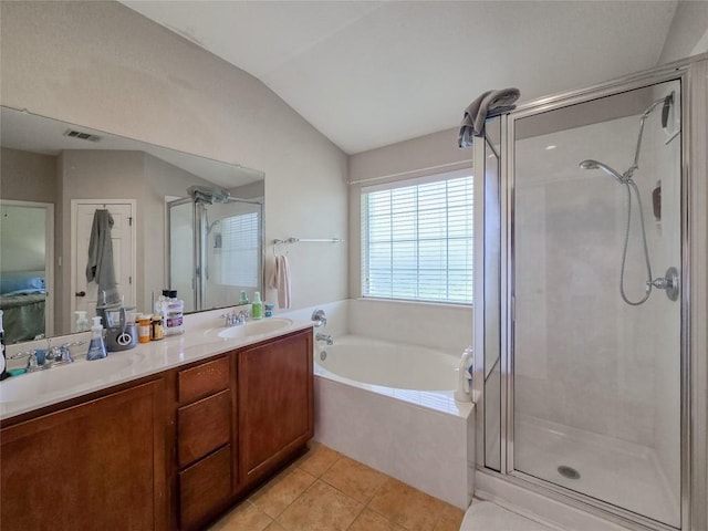 11704 Fletcher Hall Ln, Austin, TX 78717 - bathroom with a stall shower, a bath, double vanity, vaulted ceiling, and tile patterned flooring