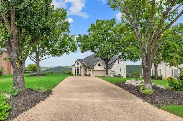 4700 River Place Blvd Unit 3, Austin, TX 78730 - french country style house featuring concrete driveway, a front lawn, and an attached garage