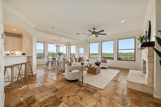 4700 River Place Blvd Unit 3, Austin, TX 78730 - living room with stone tile floors, ornamental molding, a ceiling fan, arched walkways, and recessed lighting